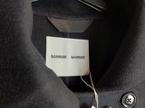 a close up of a black shirt with a tag on it