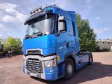 a large blue truck parked in a parking lot