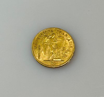 a close up of a gold coin on a white surface