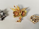 three different types of brooches on a white surface
