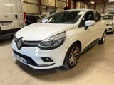 une voiture blanche garée dans un garage, avec d'autres voitures en arrière-plan