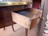 a wooden desk with a drawer on top of it