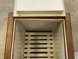 a white box that has a drain in it