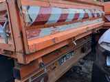 a dump truck that is parked next to a car