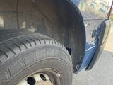 a close up of a tire on a blue truck