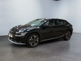 the black car is parked in a large room with a white wall