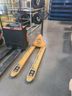 a forklift and a pallet in a warehouse