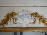 a gold leaf decoration on the wall of a room