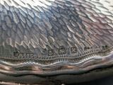 a close up of a silver plate with writing on it