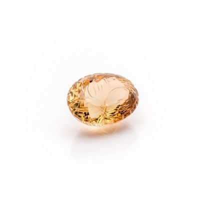 a close up of a yellow diamond on a white surface