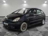 a picture of a small black car parked on a checkered floor
