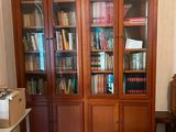 a book case with many books on it in a room