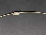 a close up of a piece of wire on a black surface