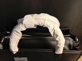 a black bag with a white glove on top of it
