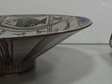 a bowl and a spoon sitting on a table