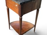 a small wooden table with a marble top on it