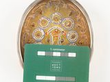 a green credit card sitting on top of a silver plate
