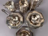 six pieces of silverware are arranged in a circle on a table