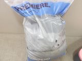 a cat that is sitting in a bag on the floor