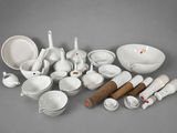 a lot of white dishes and utensils on the table