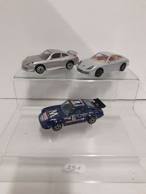 three toy cars that are on display on a clear shelf