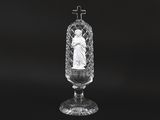 black and white photograph of a glass vase with a statue in it