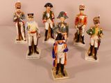 seven figurines of men dressed in military uniforms