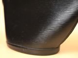 a close up of a black purse on a table