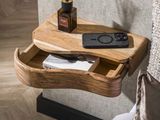 a wooden table with a phone and a remote control on it