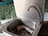 a sink with a faucet and a hose in it