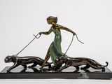 bronze statue of a woman walking two dogs on a leash