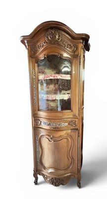 a wooden cabinet with a glass door on top of it