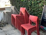 many red chairs lined up next to a chalk board