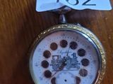 a pocket watch on a table with a price tag on it