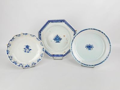 three blue and white plates with designs on them on a white surface