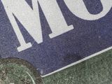 a blue and white sign with the word mom on it
