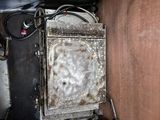 a dirty oven in the corner of a dirty room