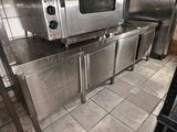 a silver microwave sitting on top of a stainless steel counter