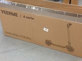a cardboard box with a scooter on it sitting on the floor