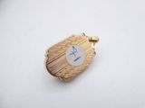 a close up of a small gold locke with a blue stone on it