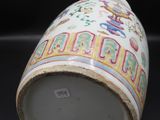 a white cup with colorful designs on it on a black surface