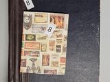 a book with stamps on it and a clock on the cover