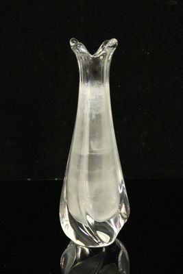 a clear glass vase sitting on a black surface