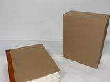 two books sitting next to each other on a white surface