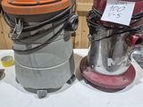 two vacuums sitting on a table next to each other