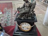 a statue of a woman sitting on top of a clock