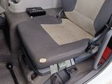 a seat in the back of a car with a remote control