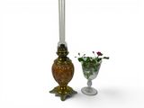 two candles that are next to a vase of flowers