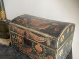 a small chest sitting on top of a dresser