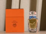 a bottle of perfume sitting on a table next to a box